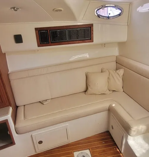 Robin Ann Yacht Photos Pics 2004 Carolina Classic 35 Express cabin with beige seating and wooden accents.