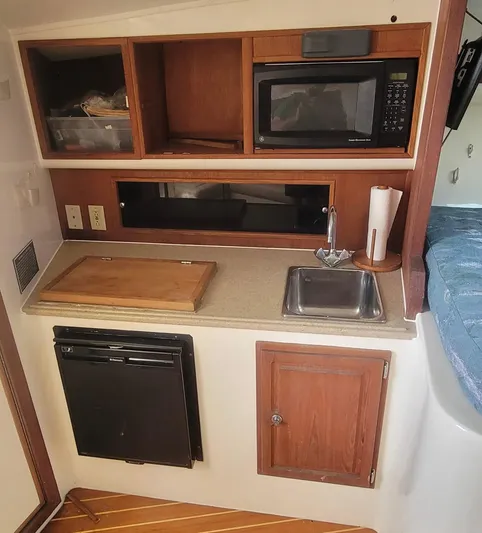 Robin Ann Yacht Photos Pics 2004 Carolina Classic 35 Express galley with microwave, sink, and storage cabinets.