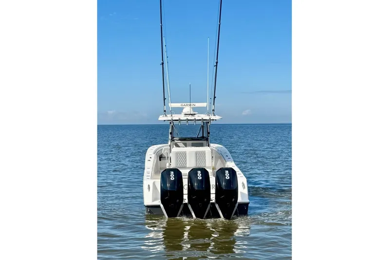  Yacht Photos Pics 2020 Invincible 36 Open Fisherman boat with triple engines on calm water.