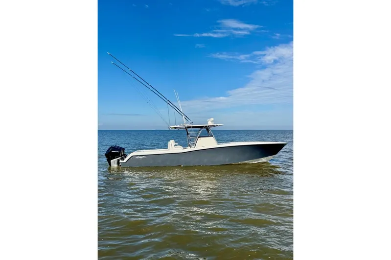  Yacht Photos Pics 2020 Invincible 36 Open Fisherman boat on calm ocean waters under blue sky.