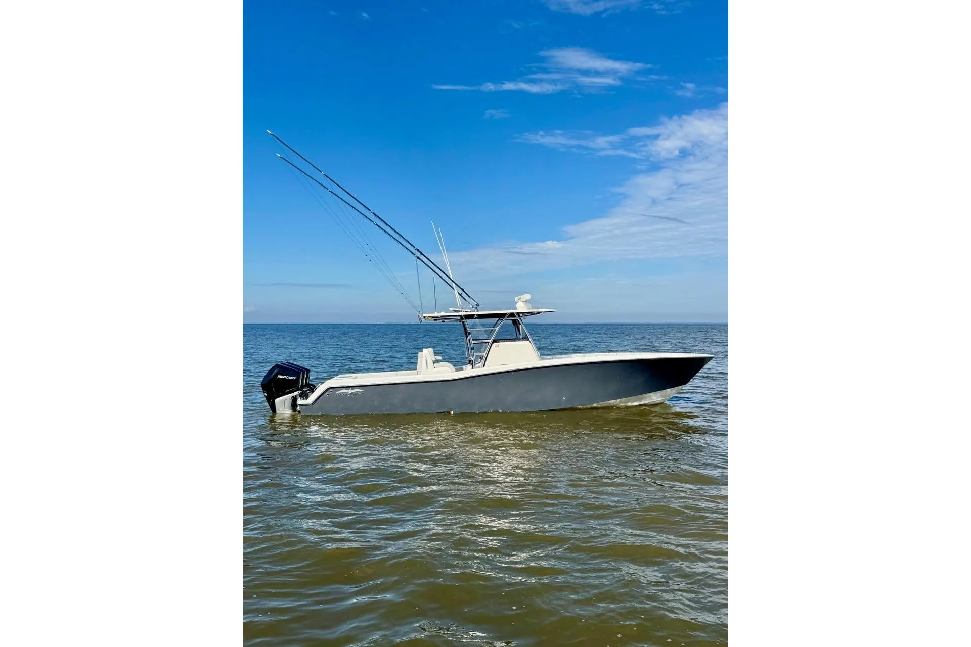 2020 Invincible 36 Open Fisherman boat on calm ocean waters under blue sky.