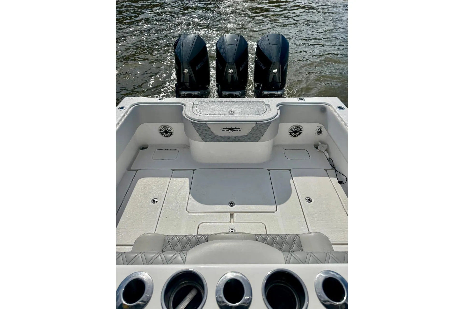 2020 Invincible 36 Open Fisherman boat with triple outboard motors on water.