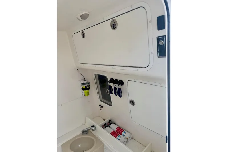  Yacht Photos Pics 2020 Invincible 36 Open Fisherman interior with storage compartments and sink.