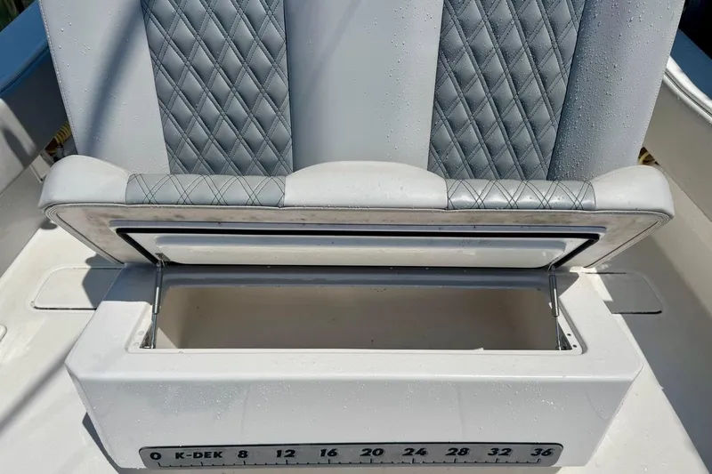  Yacht Photos Pics Open storage compartment on 2020 Invincible 36 Open Fisherman boat with cushioned seating.