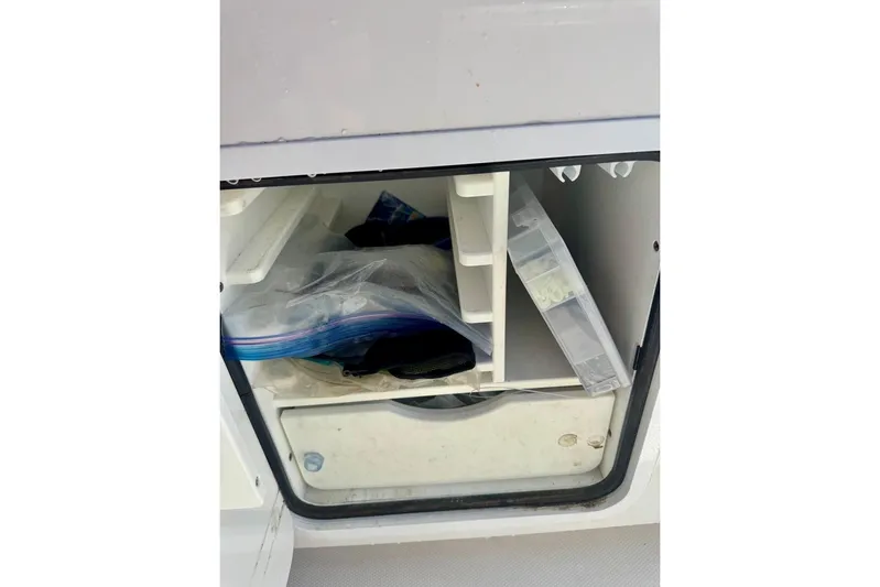  Yacht Photos Pics Storage compartment on a 2020 Invincible 36 Open Fisherman boat with organized gear.