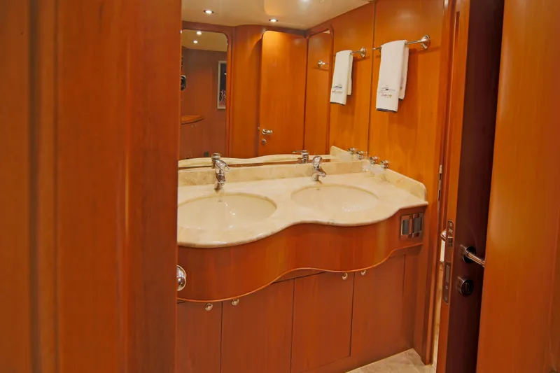 Southern Lady Yacht Photos Pics Luxurious wooden bathroom interior on 2006 Horizon E73 yacht with dual sinks and elegant fixtures.