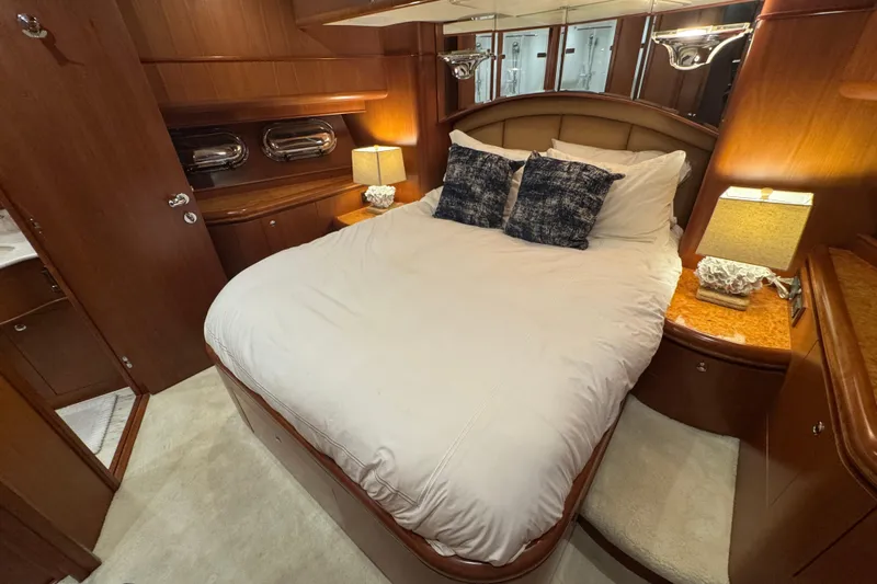 Southern Lady Yacht Photos Pics Luxurious bedroom interior in 2006 Horizon E73 yacht with elegant wood finishes.