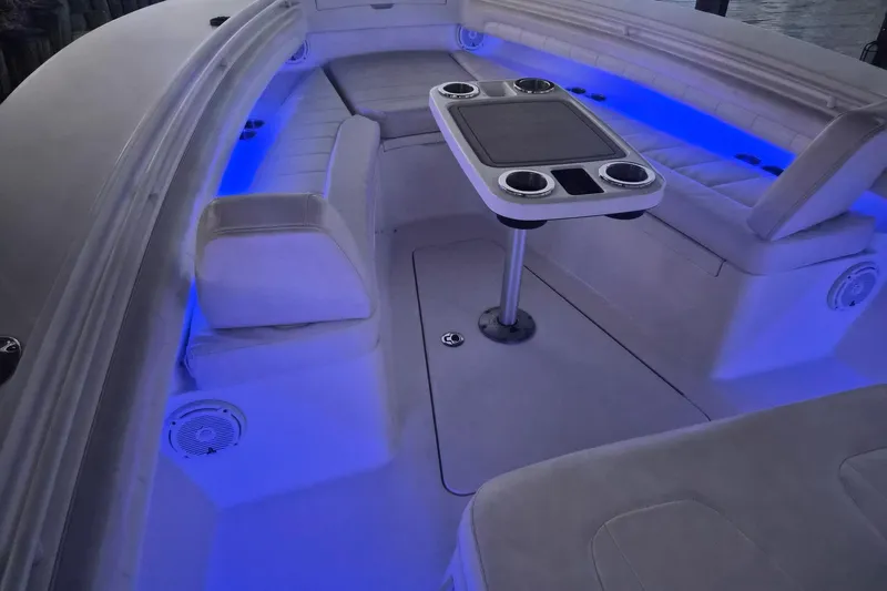  Yacht Photos Pics 2018 Regulator 28 boat interior with blue LED lighting and seating area.