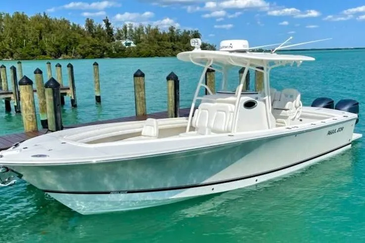  Yacht Photos Pics 2018 Regulator 28 boat docked in clear turquoise water, under a sunny sky.