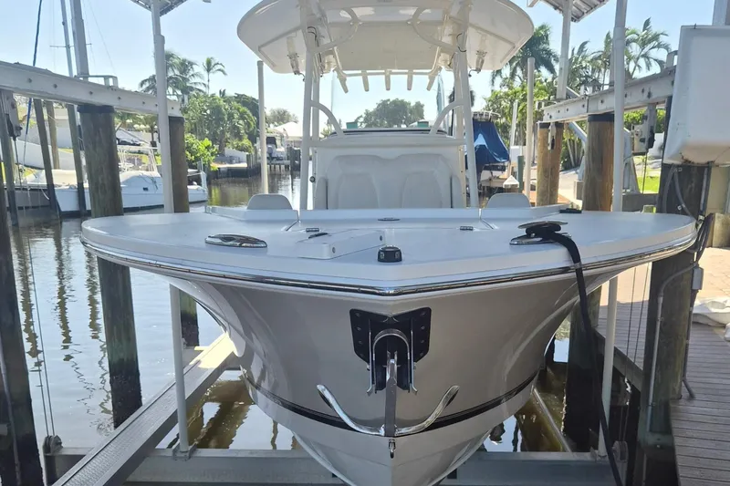  Yacht Photos Pics 2018 Regulator 28 boat docked, showcasing sleek design and spacious deck.