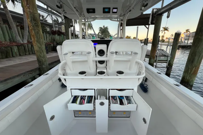  Yacht Photos Pics 2018 Regulator 28 boat interior with storage compartments open at a marina.