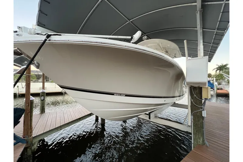  Yacht Photos Pics 2018 Regulator 28 boat on lift under canopy at marina dock.