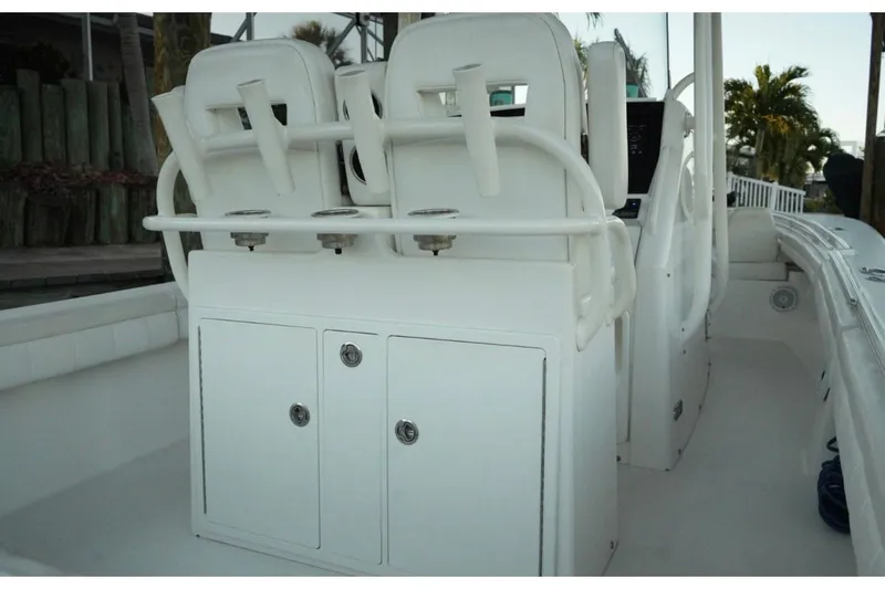  Yacht Photos Pics 2018 Regulator 28 boat interior with white seating and storage compartments.
