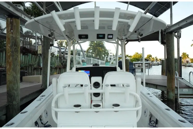  Yacht Photos Pics 2018 Regulator 28 boat interior with helm, docked in a marina setting.