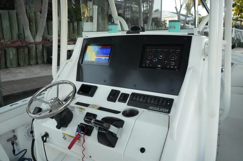  Yacht Photos Pics 2018 Regulator 28 boat dashboard with steering wheel and navigation screens.