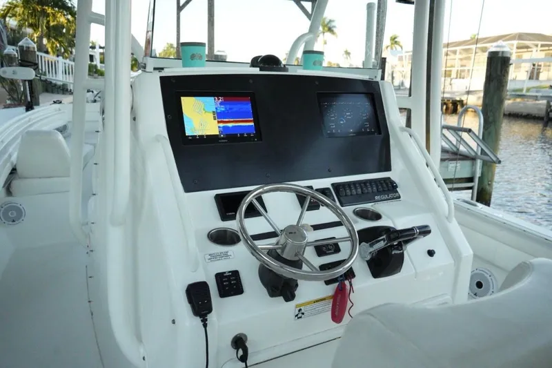  Yacht Photos Pics 2018 Regulator 28 boat dashboard with navigation screens and steering wheel.