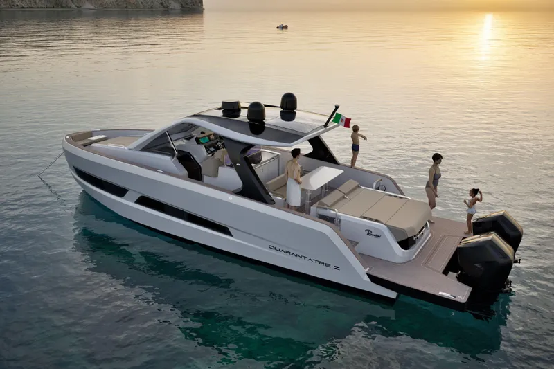 Yacht Photos Pics Luxury 2026 Ranieri QUARANTATRE Z yacht on serene water at sunset, with people enjoying the deck.