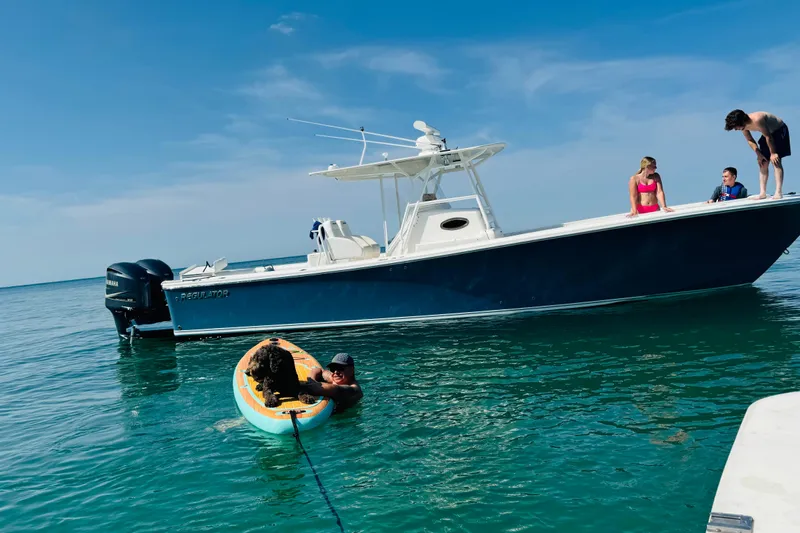  Yacht Photos Pics 2010 Regulator 34SS boat on water with people and a paddleboard.