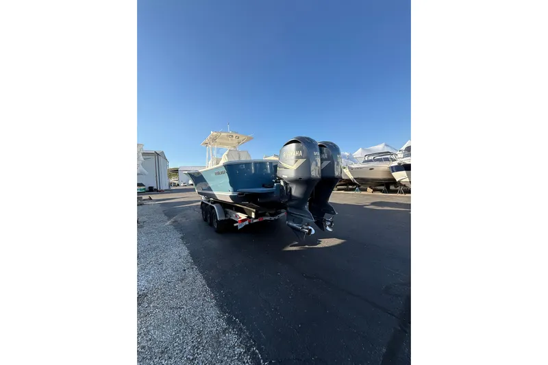  Yacht Photos Pics 2010 Regulator 34SS boat with dual Yamaha engines on a trailer, parked outdoors.