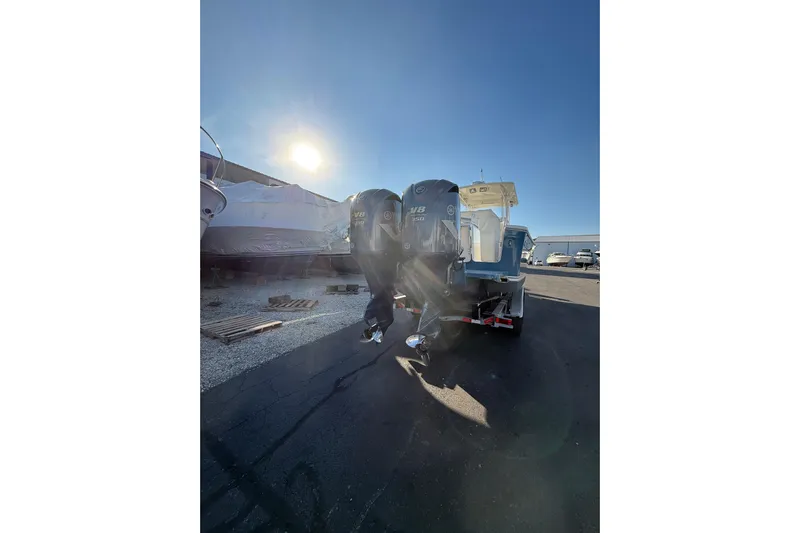  Yacht Photos Pics 2010 Regulator 34SS boat with dual outboard engines in a sunny marina setting.