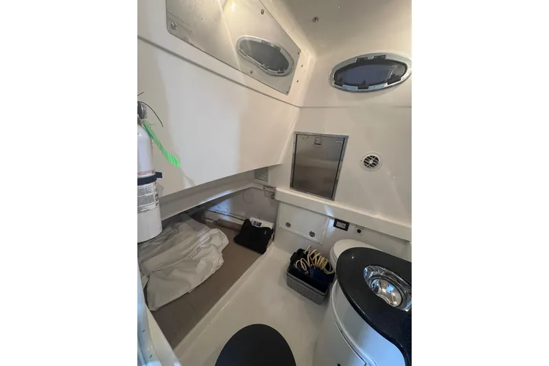  Yacht Photos Pics 2010 Regulator 34SS cabin interior with bed, storage, and portholes.