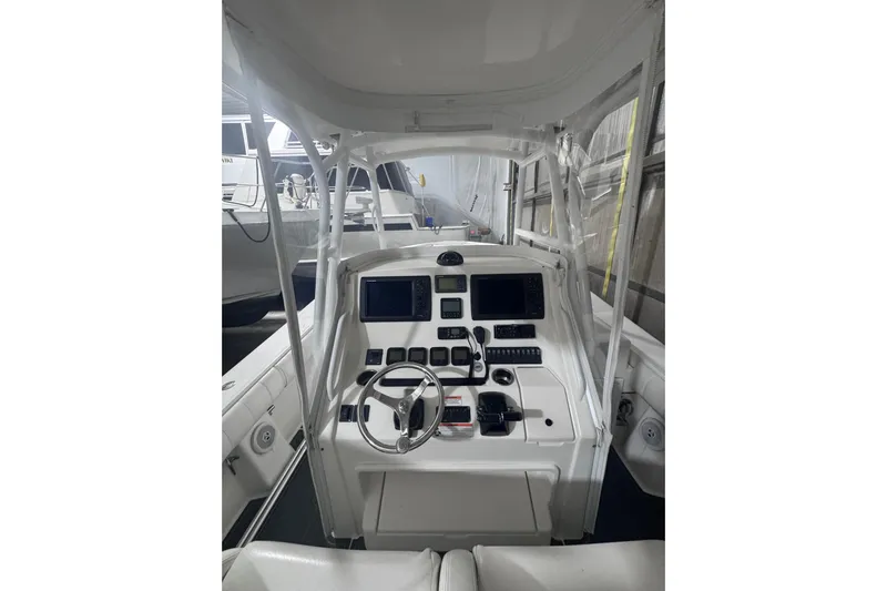  Yacht Photos Pics 2010 Regulator 34SS boat cockpit with steering wheel and navigation controls.