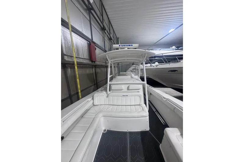  Yacht Photos Pics 2010 Regulator 34SS boat in storage, featuring white seating and a Furuno radar.