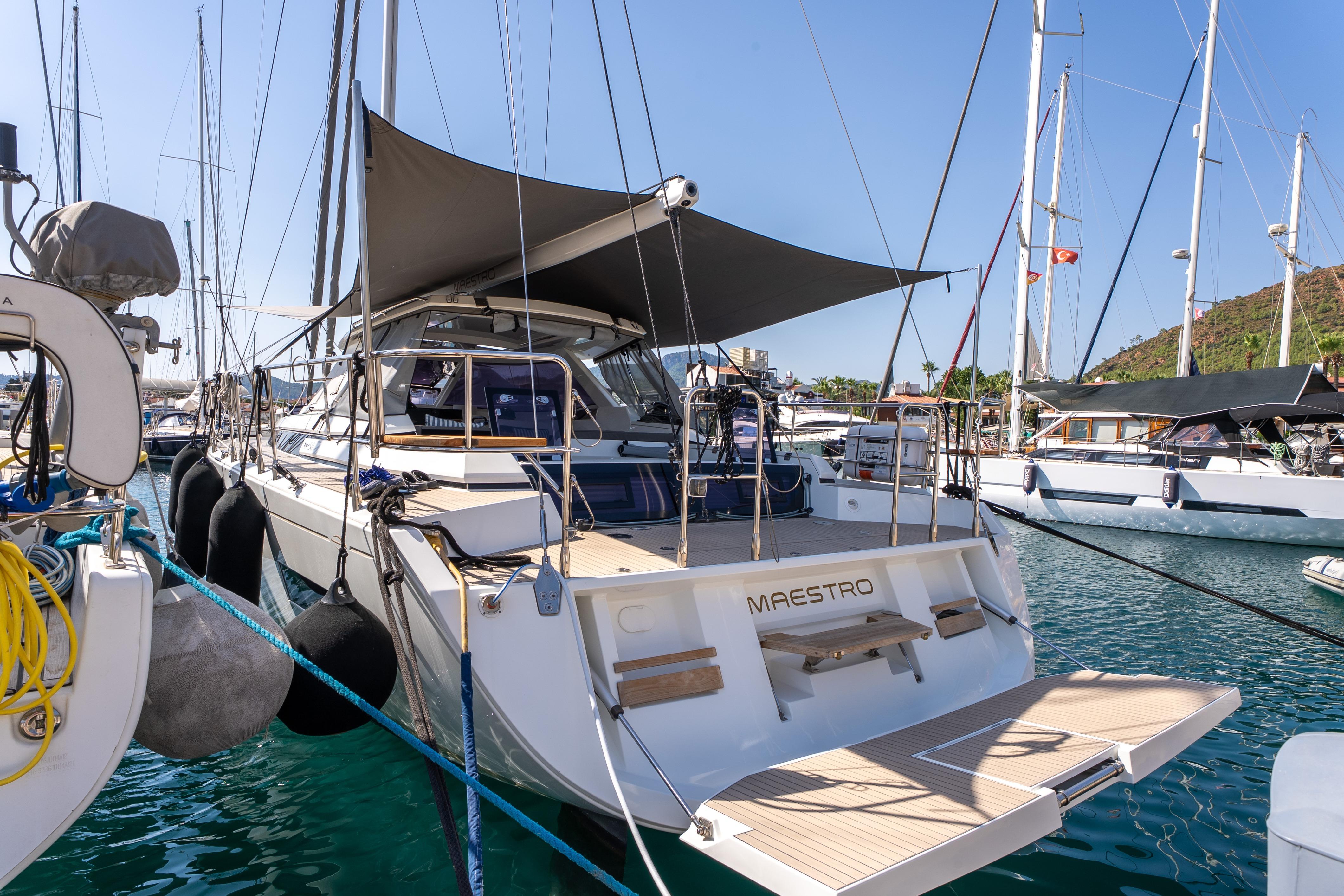 Luxury Amel 50 yacht, 2019 model, docked in marina with sunshade and open deck.