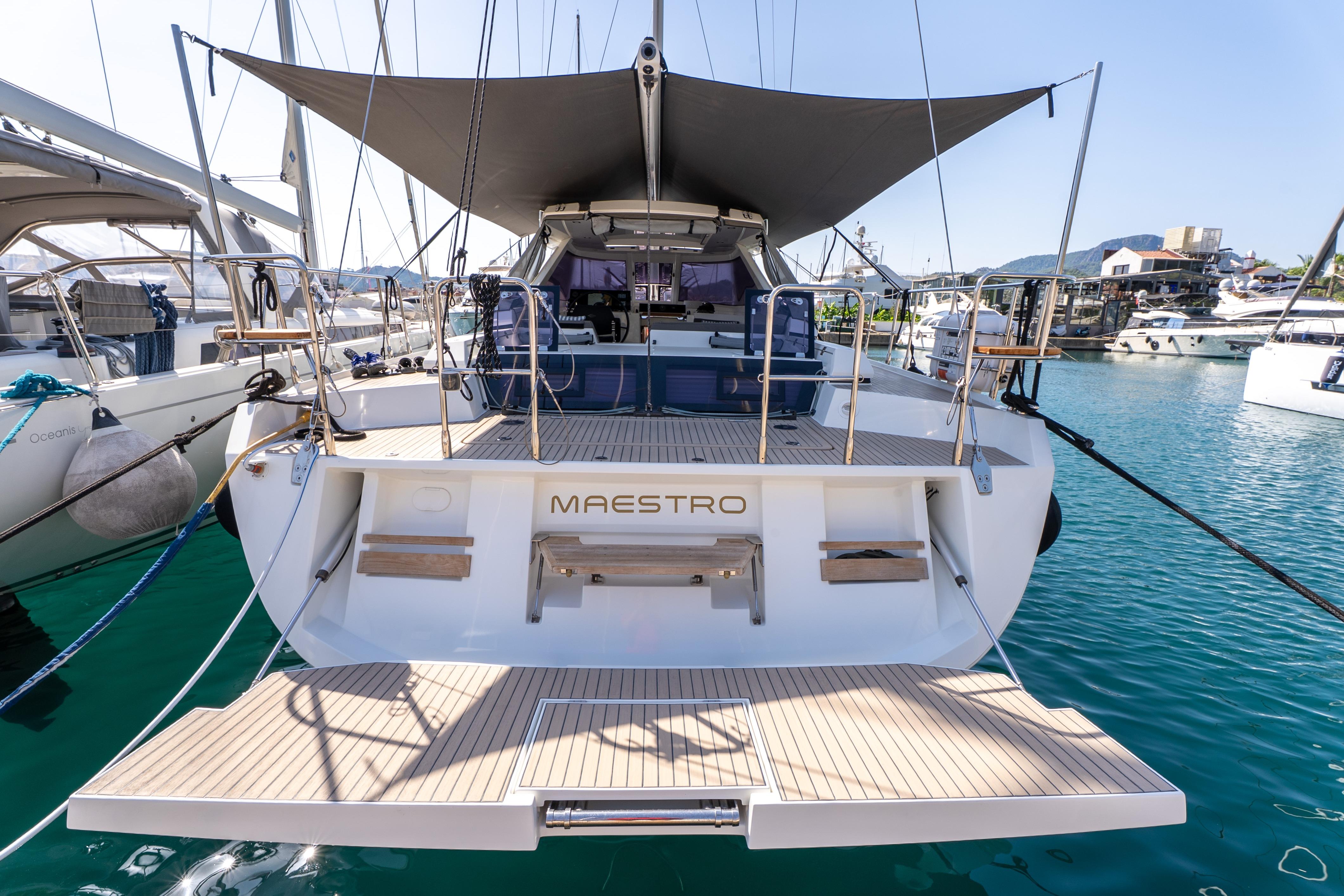 Luxury Amel 50 yacht, 2019 model, docked in marina with sunshade and spacious deck.