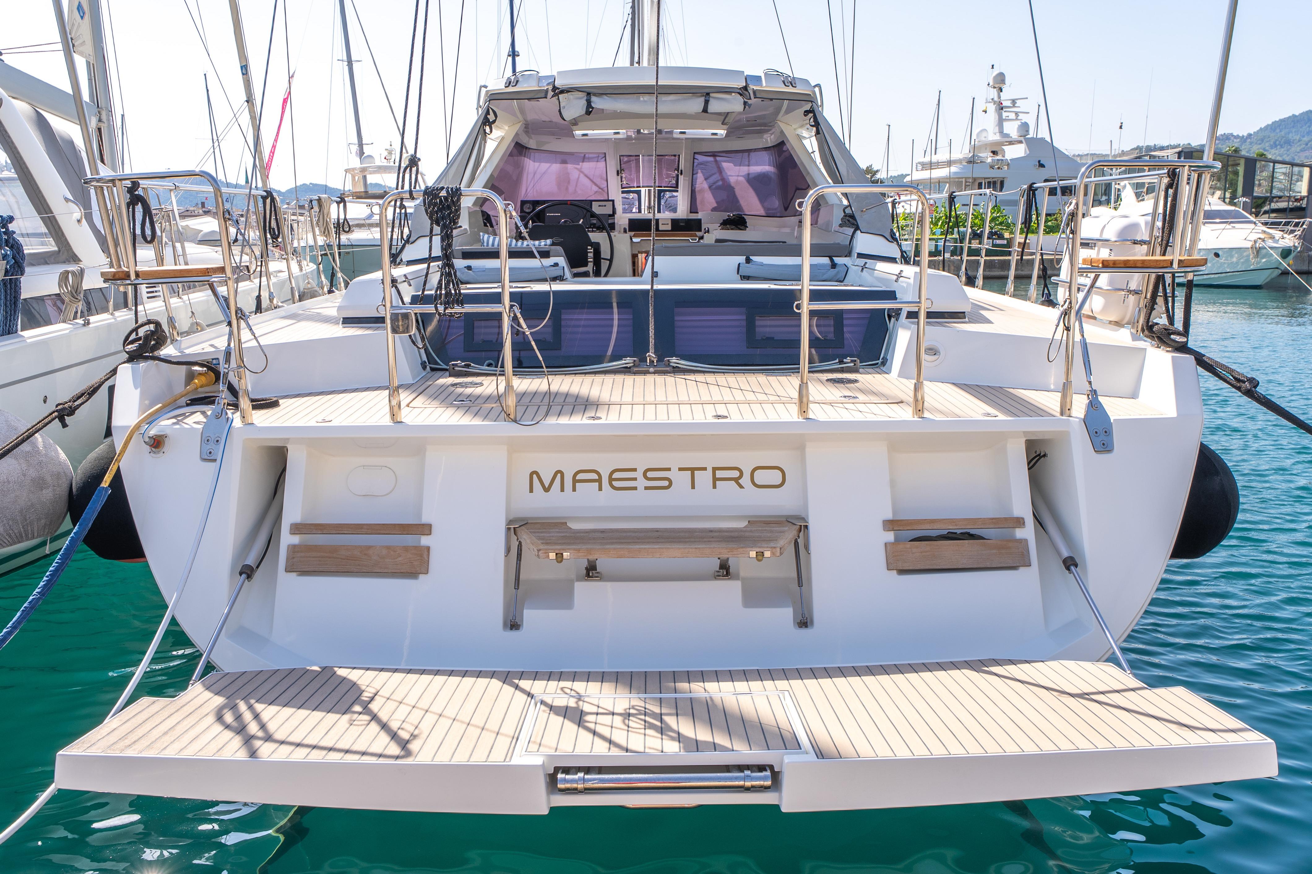 Sleek 2019 Amel 50 yacht "Maestro" docked in a marina, showcasing elegant design.