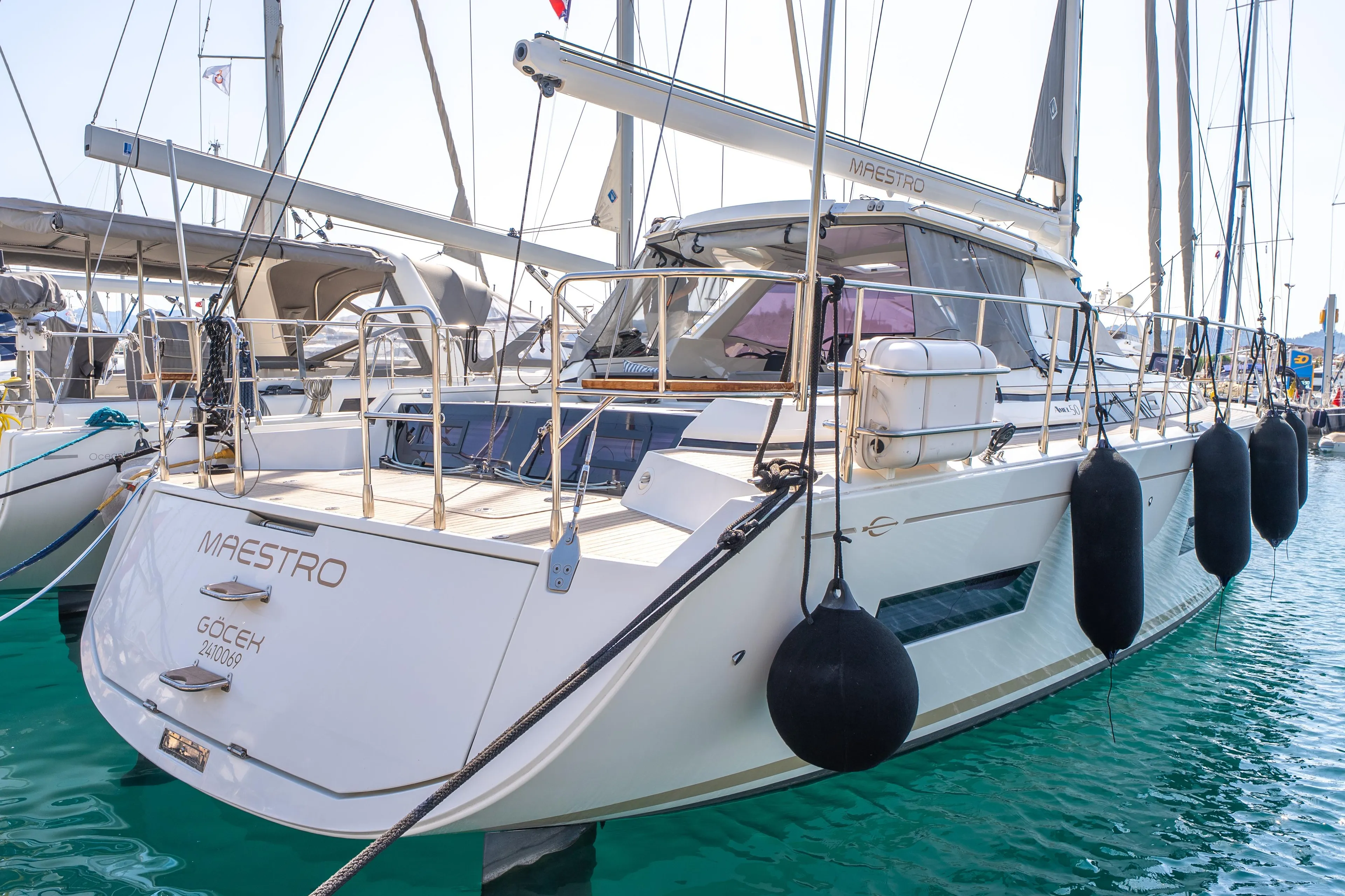 Luxury Amel 50 yacht, 2019 model, docked in marina with fenders and sleek design.