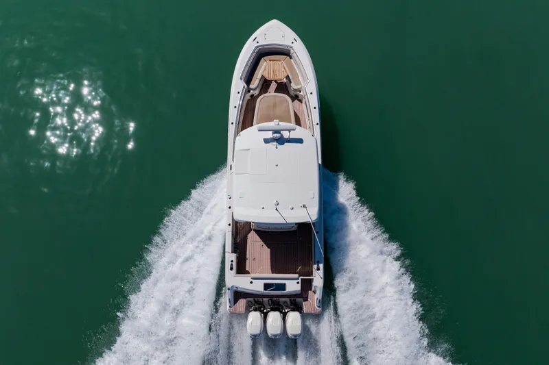 Spec-tacular Li Li Yacht Photos Pics Aerial view of 2019 Boston Whaler 380 Outrage cruising on green water.