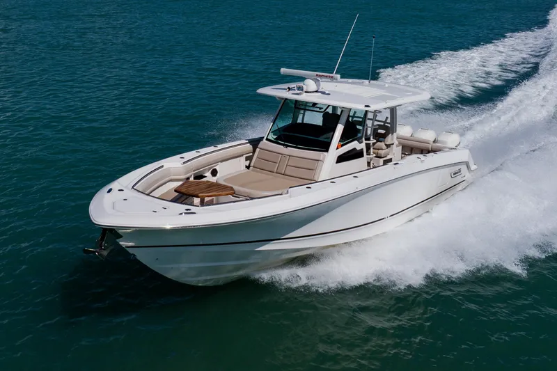 Spec-tacular Li Li Yacht Photos Pics 2019 Boston Whaler 380 Outrage cruising on open water, showcasing sleek design and performance.