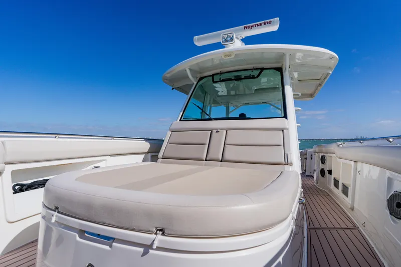 Spec-tacular Li Li Yacht Photos Pics 2019 Boston Whaler 380 Outrage boat with spacious deck and seating under clear blue sky.