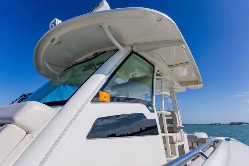 Spec-tacular Li Li Yacht Photos Pics 2019 Boston Whaler 380 Outrage boat on clear blue water under sunny sky.