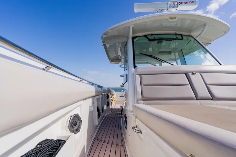 Spec-tacular Li Li Yacht Photos Pics 2019 Boston Whaler 380 Outrage boat deck with seating, under clear blue sky.