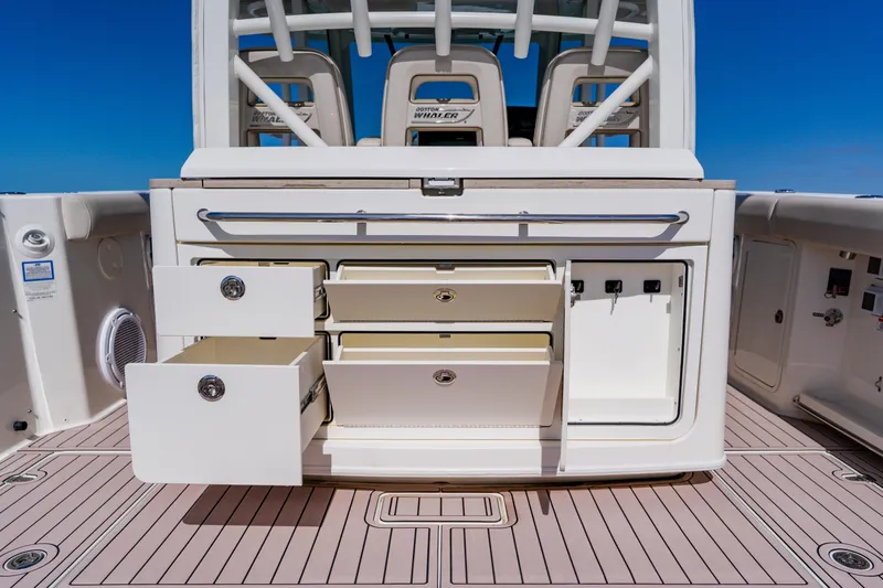 Spec-tacular Li Li Yacht Photos Pics 2019 Boston Whaler 380 Outrage boat storage compartments with open drawers and cabinets.