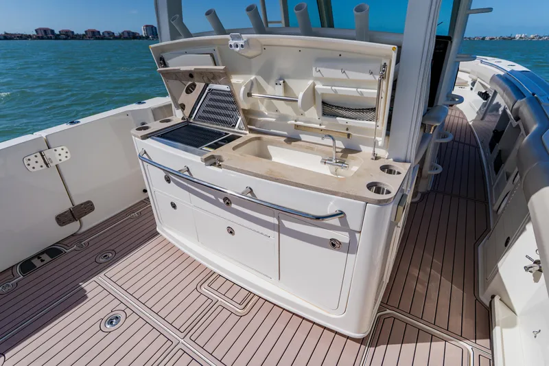 Spec-tacular Li Li Yacht Photos Pics 2019 Boston Whaler 380 Outrage boat deck with outdoor kitchen and sink.