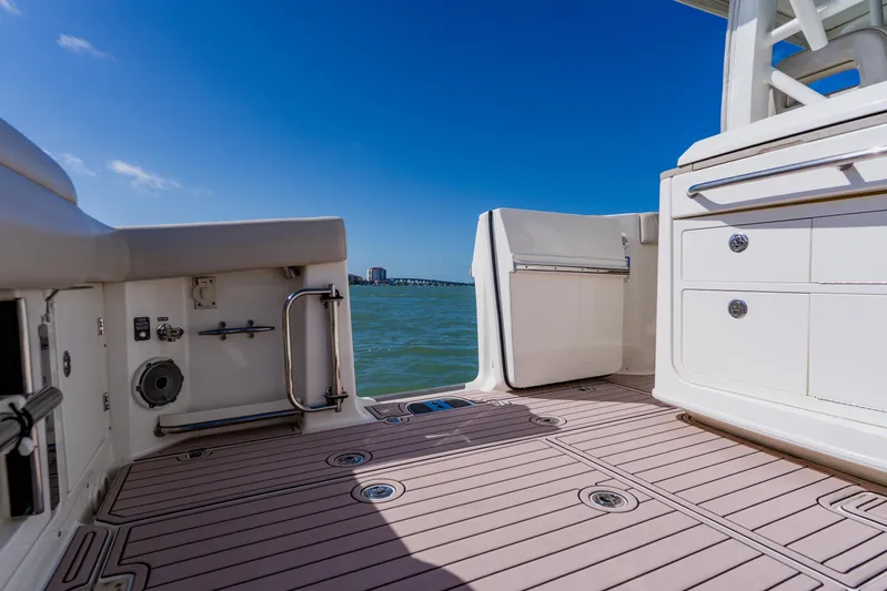 Spec-tacular Li Li Yacht Photos Pics 2019 Boston Whaler 380 Outrage boat deck with ocean view and clear blue sky.