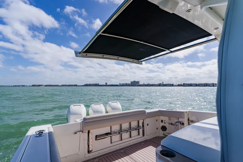 Spec-tacular Li Li Yacht Photos Pics 2019 Boston Whaler 380 Outrage boat with ocean view and retractable sunshade.