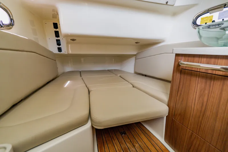 Spec-tacular Li Li Yacht Photos Pics 2019 Boston Whaler 380 Outrage cabin interior with beige seating and wood accents.