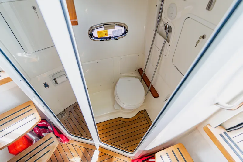 Spec-tacular Li Li Yacht Photos Pics 2019 Boston Whaler 380 Outrage boat bathroom with wooden flooring and compact design.