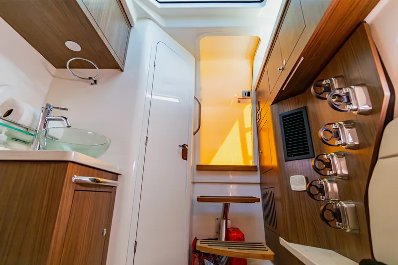 Spec-tacular Li Li Yacht Photos Pics 2019 Boston Whaler 380 Outrage interior with modern wood cabinetry and glass sink.
