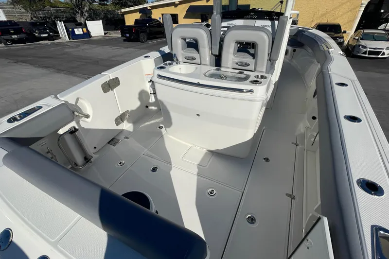  Yacht Photos Pics 2025 Boston Whaler 280 Outrage boat interior, featuring seating and storage compartments.