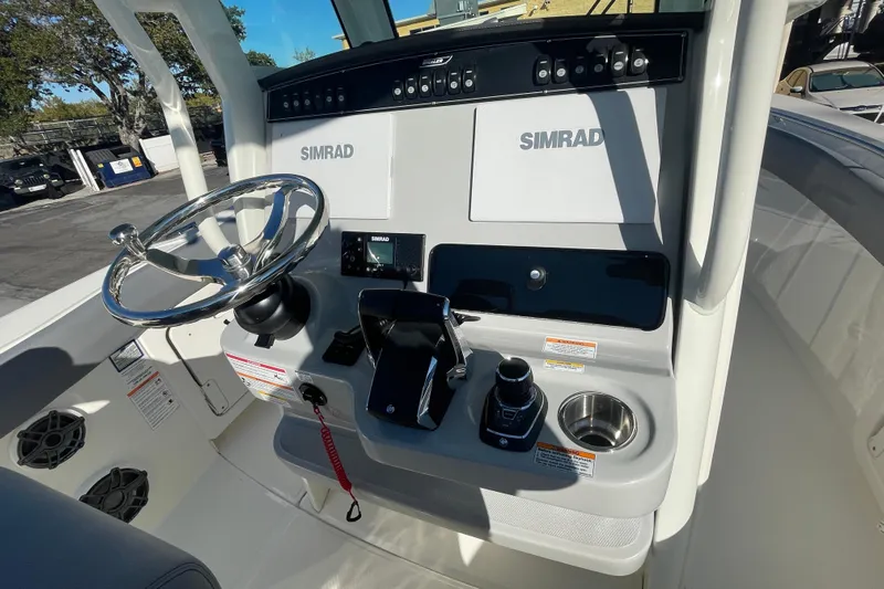  Yacht Photos Pics 2025 Boston Whaler 280 Outrage helm with Simrad electronics and modern controls.