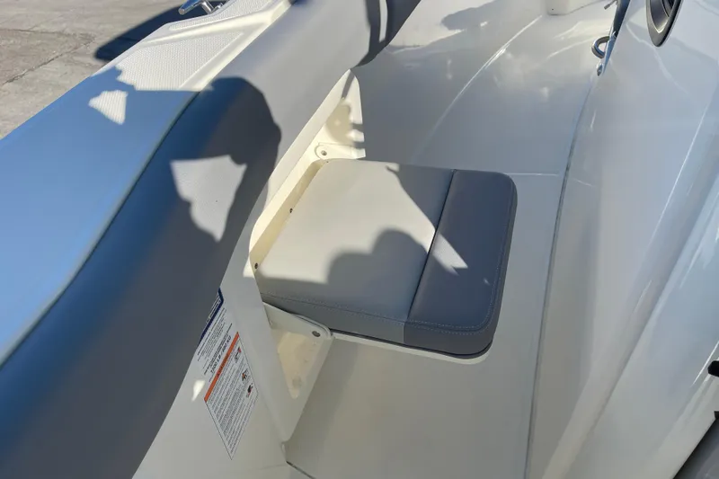  Yacht Photos Pics 2025 Boston Whaler 280 Outrage boat seat detail with gray cushion and white interior.
