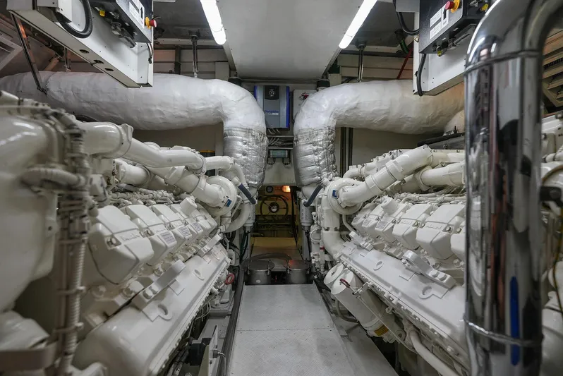 Querencia Yacht Photos Pics Engine room of a 2004 Mangusta 72 Hardtop yacht with dual engines.