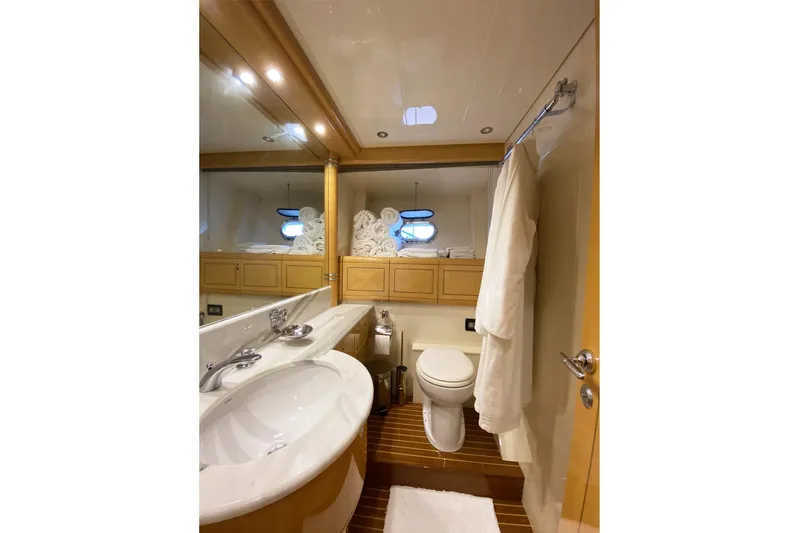 Querencia Yacht Photos Pics Luxurious bathroom in 2004 Mangusta 72 Hardtop yacht with modern fixtures and elegant design.