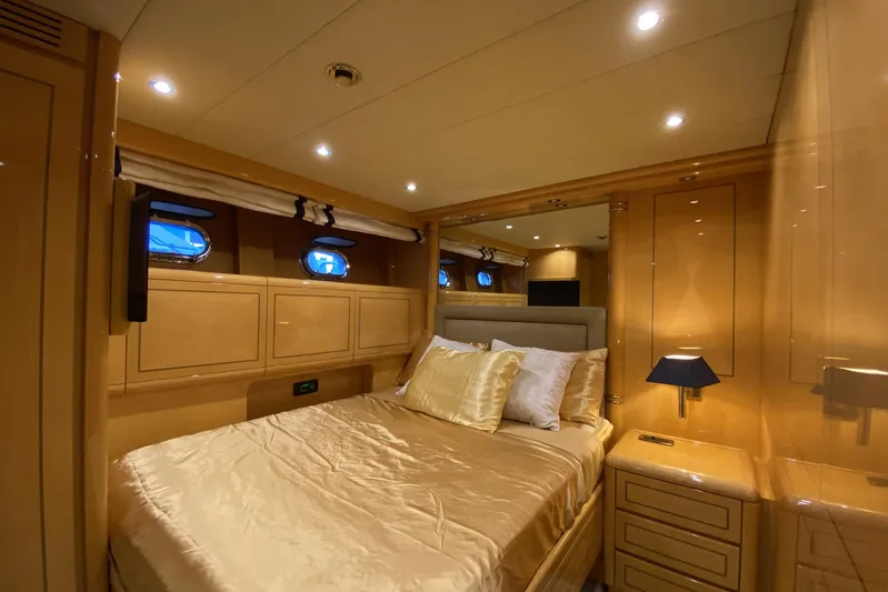Querencia Yacht Photos Pics Luxurious bedroom interior of 2004 Mangusta 72 Hardtop yacht with elegant lighting.