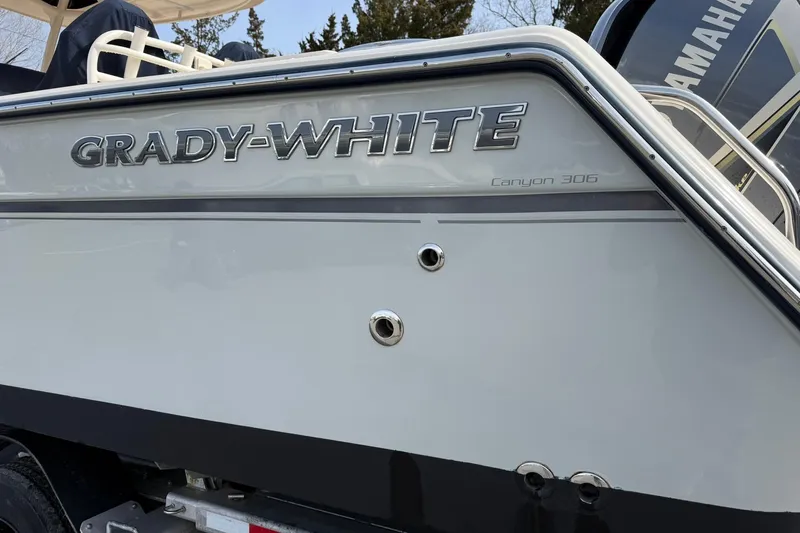  Yacht Photos Pics 2019 Grady-White Canyon 306 boat, side view with logo and details.